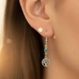 Elegant silver earring with blue beads and tree of life charm.