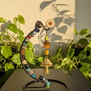 Handcrafted mushroom earrings displayed on a decorative stand.